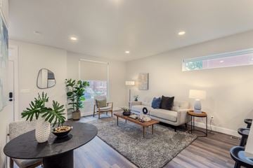 St. Louis townhouse for rent - A living room with a black table and a white couch.