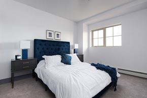Ft Mcmurray apartment for rent - a bedroom with a bed and two nightstands and a window