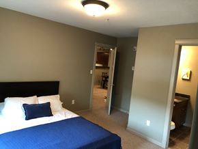 Ft Mcmurray apartment for rent - A bedroom with a bed and a blue bedspread.