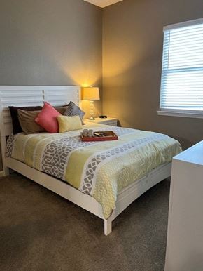 Thackerville apartment for rent - a bedroom with a bed and a table and a window