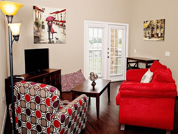 Thackerville apartment for rent - A living room with a red chair and a television.