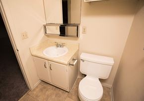 Amarillo apartment for rent - a bathroom with a toilet and a sink and a mirror