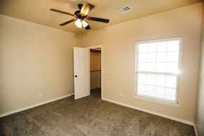 Amarillo apartment for rent - a bedroom with a ceiling fan and a door to a closet