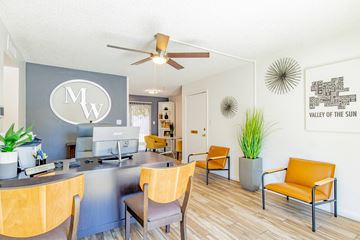 Glendale apartment for rent - a living room with a desk and chairs and a ceiling fan