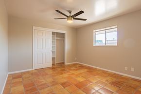 Phoenix apartment for rent - an empty room with a ceiling fan and a window