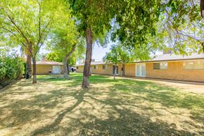 Phoenix apartment for rent - a large grassy area with trees in front of a brick building