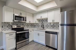 Phoenix apartment for rent - a kitchen with white cabinets and stainless steel appliances