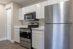 Phoenix apartment for rent - a kitchen with white cabinetry and stainless steel appliances