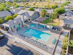 Peoria apartment for rent - an aerial view of a swimming pool and a house with a pool and chairs at Villas on Olive, Peoria, Arizona
