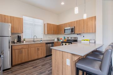 Peoria apartment for rent - a kitchen with wooden cabinets and a white counter top