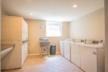 Panorama City apartment for rent - A kitchen with white appliances and a window.