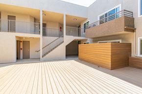 Panorama City apartment for rent - a courtyard with a wooden deck and a building with stairs