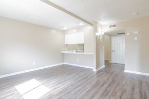 Bakersfield apartment for rent - an empty living room and kitchen with wood flooring