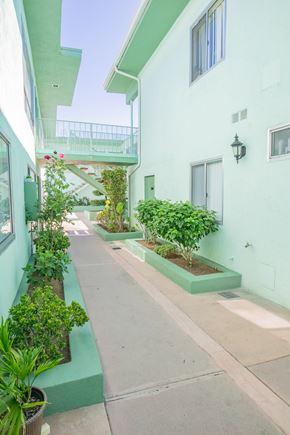 Panorama City apartment for rent - an outside view of a building with plants and a balcony