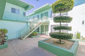 Panorama City apartment for rent - a building with stairs and a courtyard with a tree