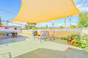 Sherman Oaks apartment for rent - a patio with chairs and a table under a canopy