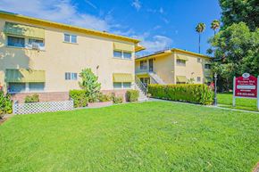 Sherman Oaks apartment for rent - a house with a green lawn and a sign in front of it