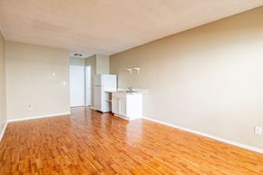 N. Hollywood apartment for rent - an empty living room with wood floors and a kitchen