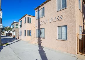 Long Beach apartment for rent - the city bliss building with a sidewalk in front of it