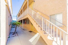 Long Beach apartment for rent - the outside of a building with stairs and a palm tree