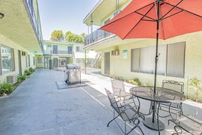 Winnetka apartment for rent - a patio with a table and chairs and an umbrella
