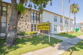 Reseda apartment for rent - a now renting sign in front of a building