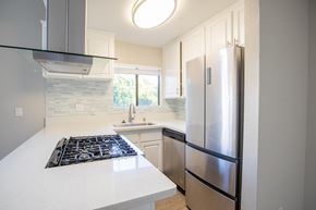 Long Beach apartment for rent - an updated kitchen with stainless steel appliances and white countertops