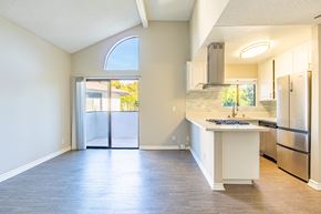 Long Beach apartment for rent - an empty kitchen with a stainless steel refrigerator and a sink