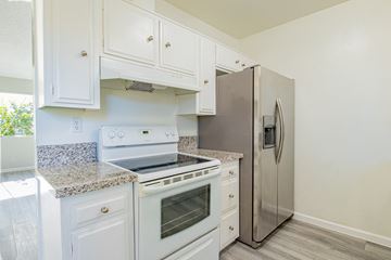 Valley Village apartment for rent - A kitchen with white cabinets and a stainless steel refrigerator.
