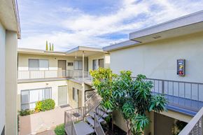 Valley Village apartment for rent - an apartment building with stairs and a balcony and plants