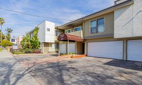 Valley Village apartment for rent - a garage with a white garage door in front of a house