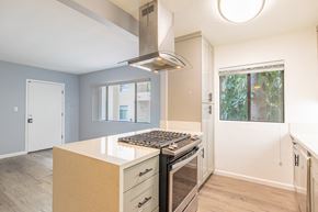 Sherman Oaks apartment for rent - an empty kitchen with a stove and a window