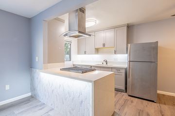 Sherman Oaks apartment for rent - A modern kitchen with a stainless steel refrigerator and a white island.