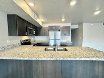 Millcreek apartment for rent - a kitchen with stainless steel appliances and granite counter tops