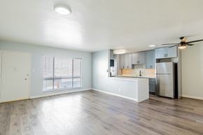 Santa Monica apartment for rent - A spacious kitchen with a refrigerator, sink, and cabinets.