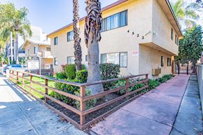Sherman Oaks apartment for rent - an apartment building with a sidewalk and palm trees