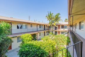 Northridge apartment for rent - the courtyard of a building with balconies and trees
