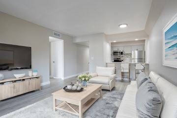 Tempe apartment for rent - A modern living room with a white sofa and a wooden coffee table.