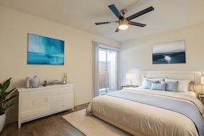 Phoenix apartment for rent - A bedroom with a large bed and a ceiling fan.