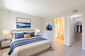 Oceanside apartment for rent - a bedroom with a bed and a closet and a bathroom