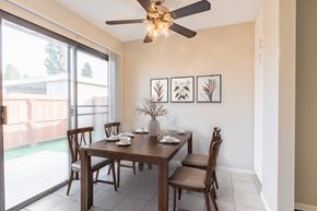 Moreno Valley apartment for rent - a dining room with a table and chairs and a ceiling fan