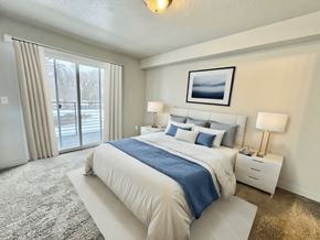 Millcreek apartment for rent - a bedroom with a bed and a sliding glass door