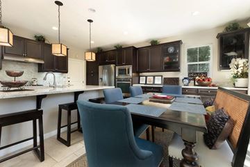 Buena Park apartment for rent - A kitchen with a table and chairs in the middle.
