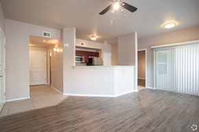 El Paso apartment for rent - an empty living room with a ceiling fan and a kitchen