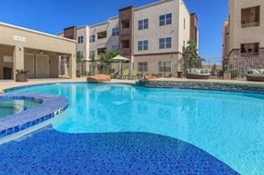 El Paso apartment for rent - a large swimming pool with an apartment building in the background