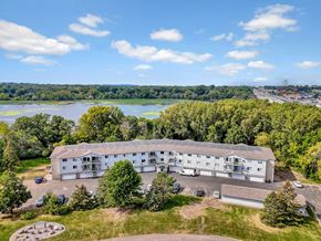 Woodbury apartment for rent - A large white building with a parking lot in front of it.