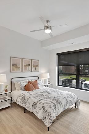 Columbia Heights apartment for rent - A bedroom with a large bed and a ceiling fan.