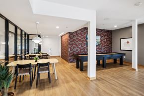 Columbia Heights apartment for rent - A modern dining room with a wooden floor and a red and white patterned wallpaper.