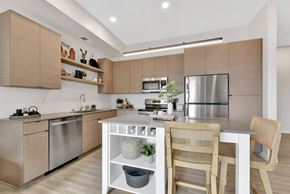 Columbia Heights apartment for rent - A modern kitchen with wooden cabinets and stainless steel appliances.