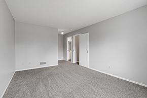Eagan townhouse for rent - a spacious living room with carpet and white walls